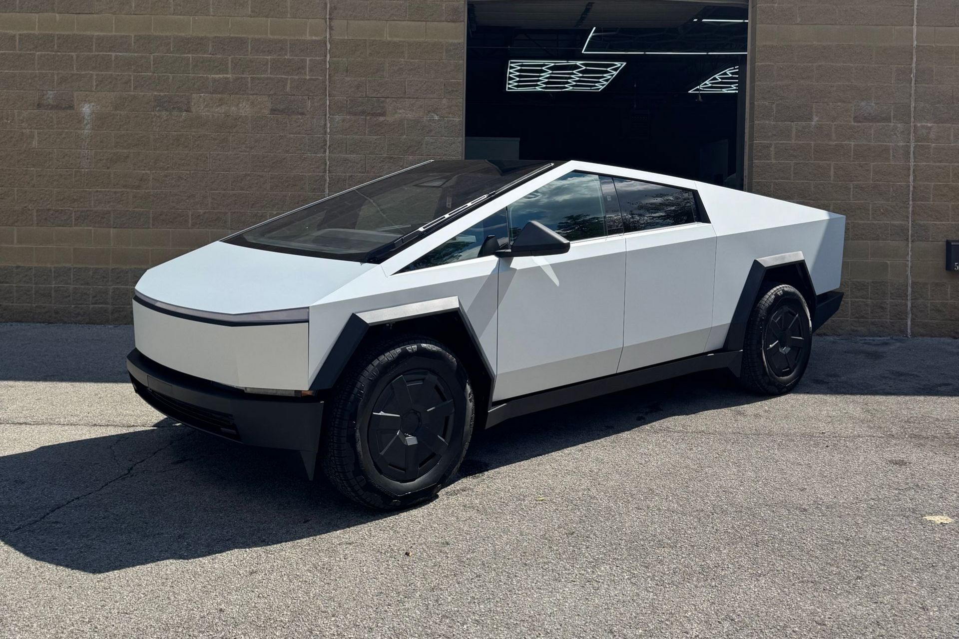 White Tesla Cybertruck outside the garage